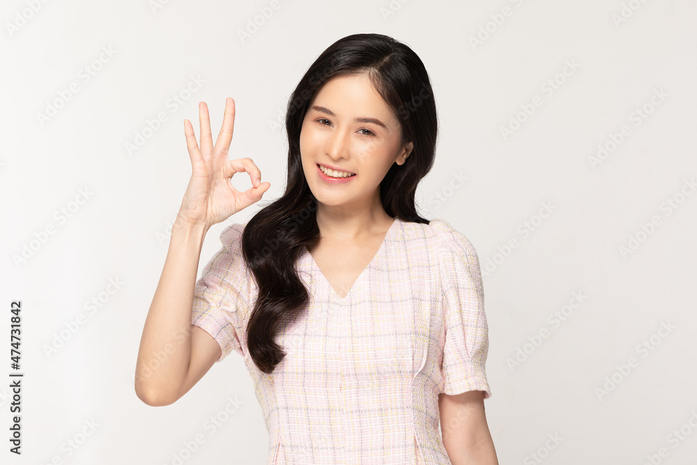 Happy attractive asian young woman smile making okay with copy space isolated on white background.Cheerful pretty girl wear casual dress showing ok sign.Positive Expression Happy attractive asian young woman smile making okay with copy space isolated on white background.Cheerful pretty girl wear casual dress showing ok sign.Positive Expression