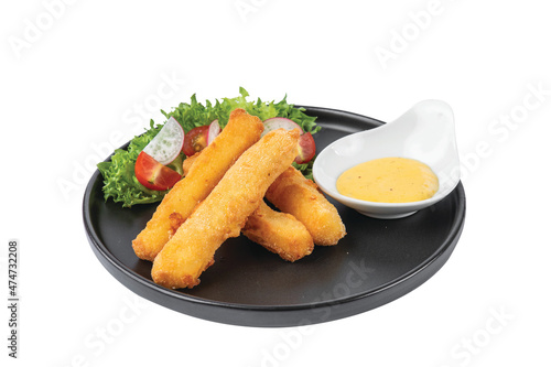 Crispy cheese sticks deep-fried .in a black dish on a white background