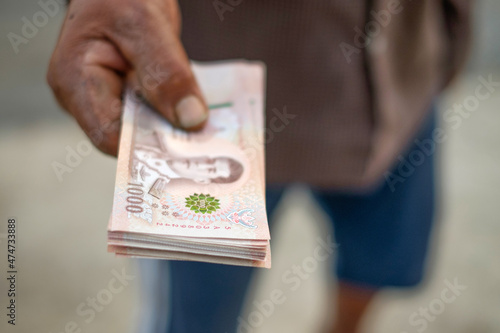 Thailand banknote money holded by farmer hand