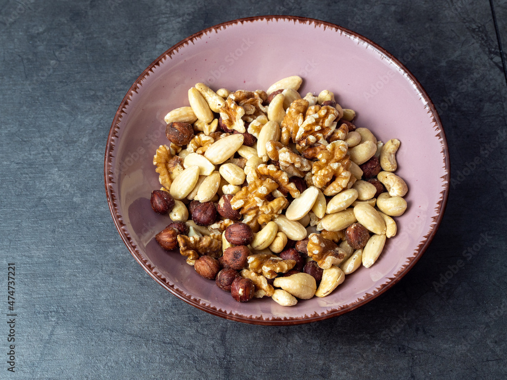 Fototapeta premium Mix nuts on a wooden background.