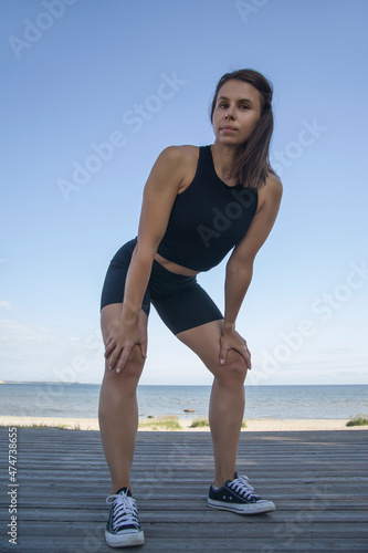 athletic young woman exercising outdoors