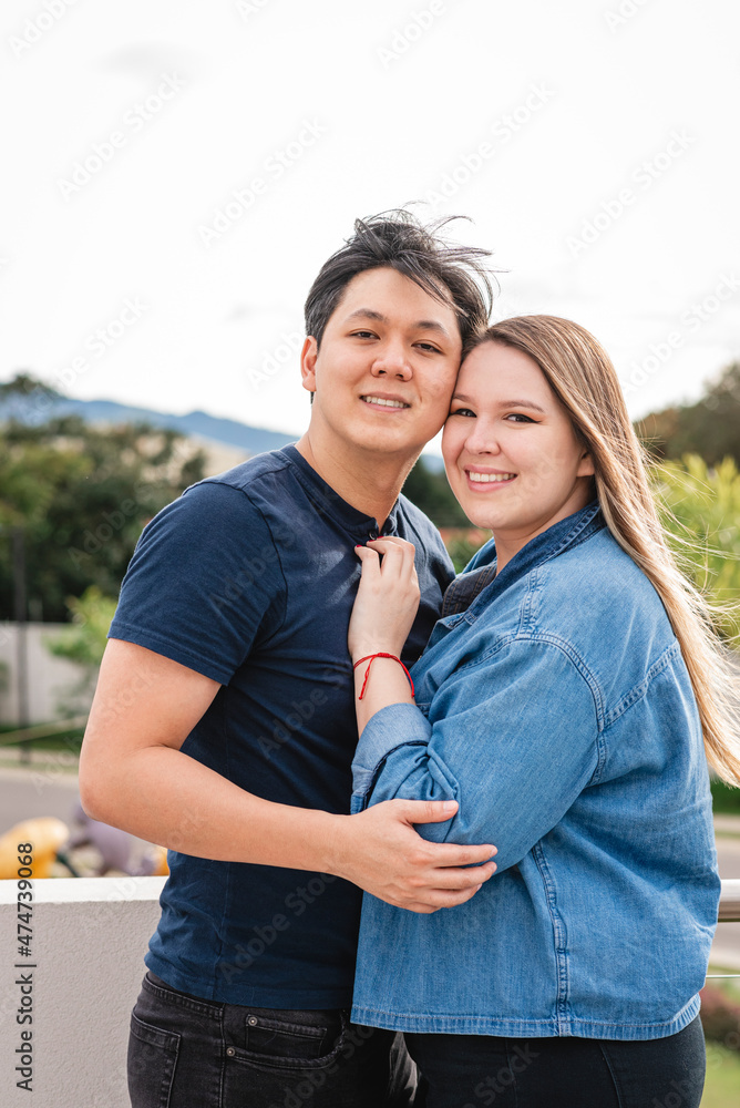 PAREJA ASIÁTICO LATINO ABRAZADOS EN EXTERIOR VIENDO A CÁMARA Stock Photo | Adobe Stock PAREJA ASIÁTICO LATINO ABRAZADOS EN EXTERIOR VIENDO A CÁMARA Stock Photo | Adobe Stock