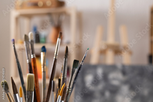 Paint brush and art painter tools at wood desk background texture. Paintbrush for painting