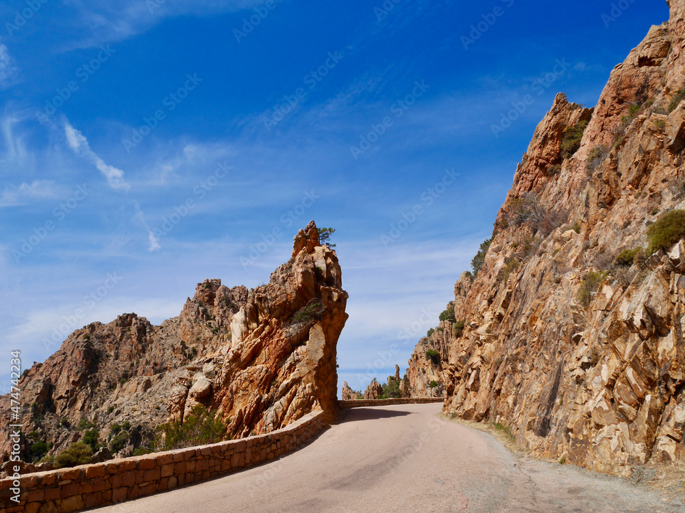 Scenic road D81 winding through the red cliffs of the Calanche, UNESCO world heritage. Corsica, France.