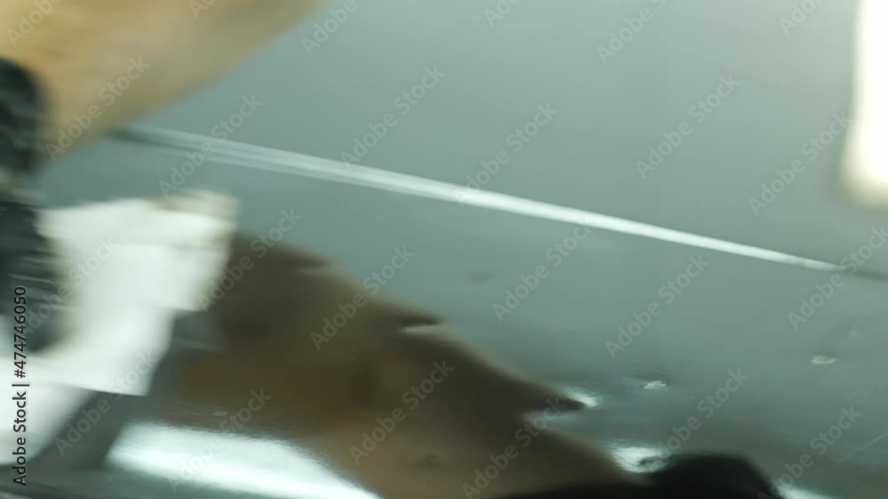Wiping a black damaged car part or roof with cloth Wiping a black damaged car part or roof with cloth