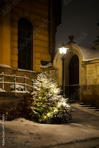 Snowy christmas tree by church 
