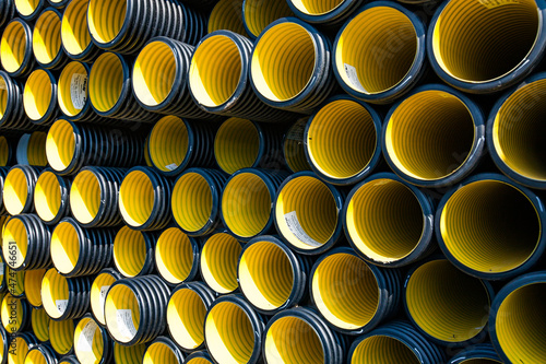 Plastic pipes production plant warehouse. Yellow PVC corrugated pipes. photo