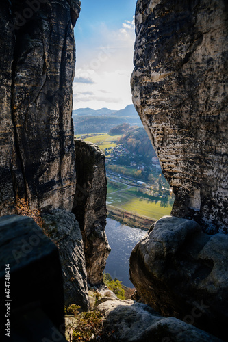 Saxon Switzerland National Park, Germany, 6 November 2021: Basteiaussicht or Bastei Rock Formations in Elbe River Valley, Sandstone Mountains Path, autumn forest landscape at sunny day, rocky valley