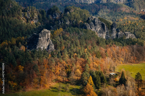 Saxon Switzerland National Park, Germany, 6 November 2021: Basteiaussicht or Bastei Rock Formations in Elbe River Valley, Sandstone Mountains Path, autumn forest landscape at sunny day, rocky valley © AnnaRudnitskaya