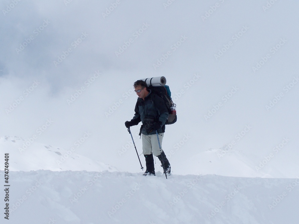 climber climbing snowy mountain, with professional equipment climber climbing snowy mountain, with professional equipment