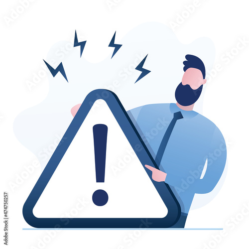 Bussinessman holds big warning sign. Triangle sign with exclamation mark. Handsome man or manager forbids something. Caution, attention sign.
