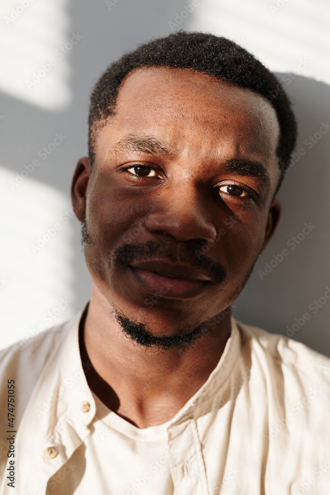 Obraz premium Close-up of African young man in shirt looking at camera isolated on white background