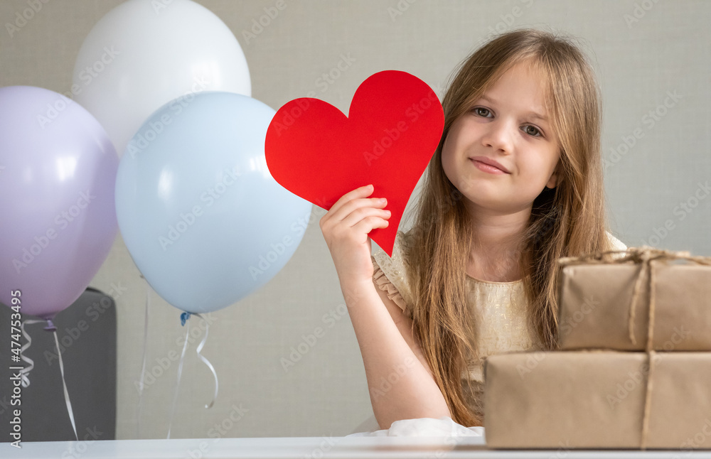 Cute little girl holding big red paper heart surrounded by zero waste gifts and air balloons. Valentines Day, love, mothers Day, romantic concept. Adorable kid smiling. Cute little girl holding big red paper heart surrounded by zero waste gifts and air balloons. Valentines Day, love, mothers Day, romantic concept. Adorable kid smiling.