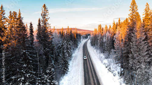 Natural background. Winter road in the forest from the height of a drone flight.
