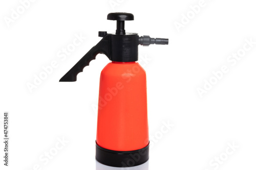 orange garden hand sprayer on white isolated background