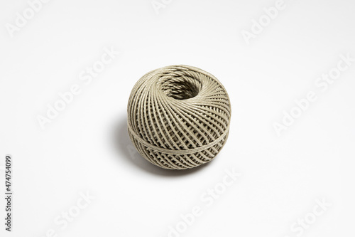 A skein of linen string, cord isolated. Coil of twine. Jute rope. Hemp thread isolated. A skein of brown wool for knitting on a white background. High-resolution photo.