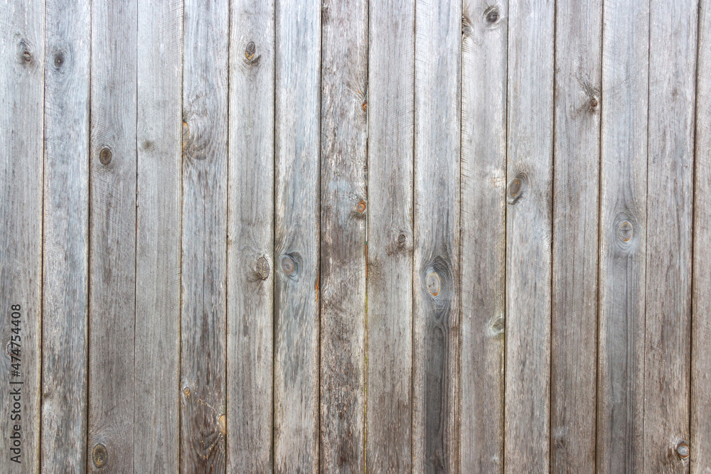 Naklejka premium Old grey wooden background with cracks and scratches in vintage style