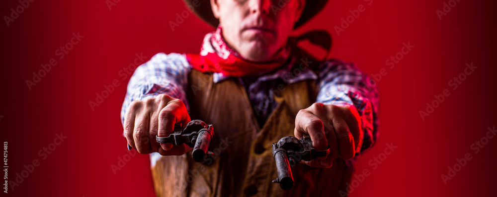 American bandit in mask, western man with hat. Portrait of farmer or cowboy in hat. Man wearing cowboy hat, gun. West, guns. Portrait of a cowboy. owboy with weapon on red background