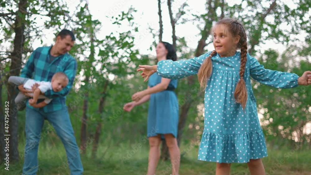 happy family in the park. girl kid throws a flying disc toy in nature. happy family kid concept. children dream playing flying disc toy plate in outdoors the park. kid playing with a toy in nature happy family in the park. girl kid throws a flying disc toy in nature. happy family kid concept. children dream playing flying disc toy plate in outdoors the park. kid playing with a toy in nature