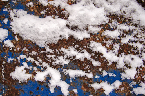 Snow flakes on the old rusty surface