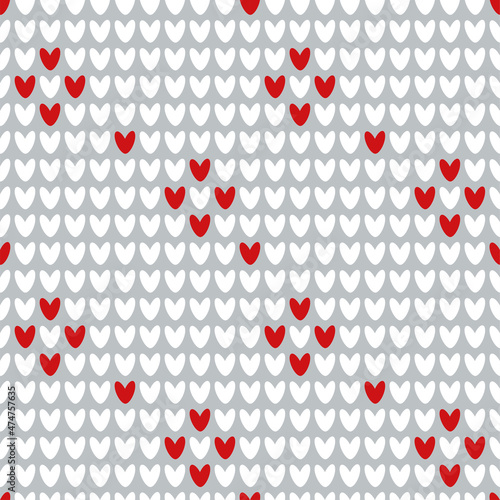 Traditional holiday red background. Knitted seamless cozy pattern with hearts. Vector illustration for Christmas and Valentine's Day.