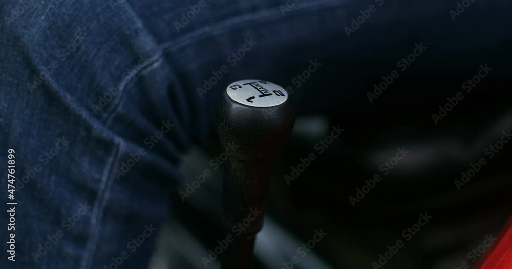 Close-up of a male hand shifting the gear lever of a modern agricultural machine Close-up of a male hand shifting the gear lever of a modern agricultural machine