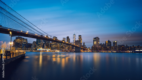 Blue hour long exposure panorama of Brooklyn Bridge and Lower Manhattan Skyline One World Trade Center against epic night sky  Dumbo  New York City