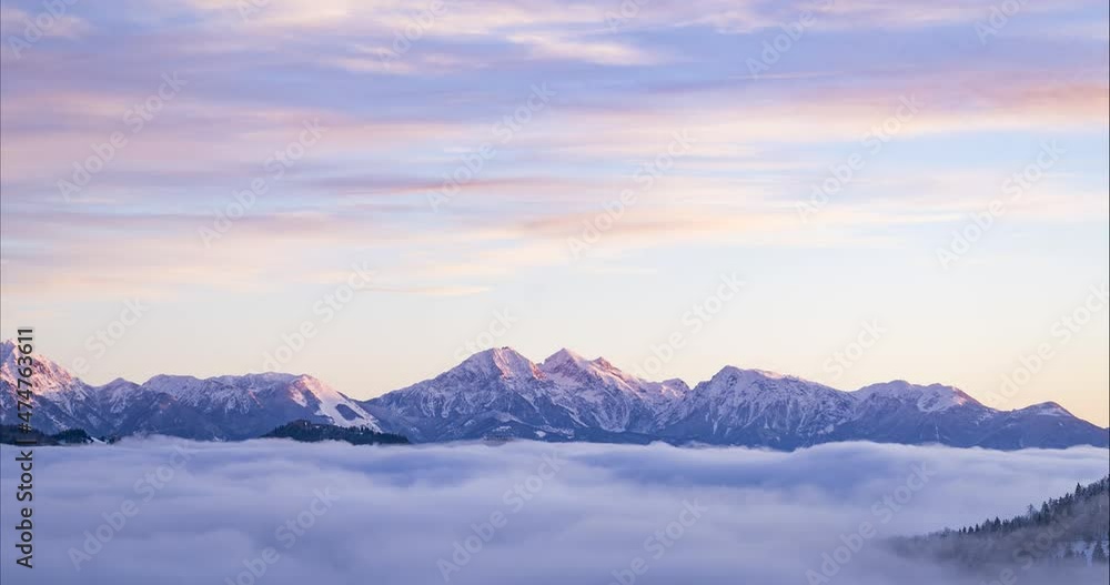 Amazing and dramatic time lapse of cloud inversion. Thick layer of mist moving in alpine valley in Slovenia. Sea of cloud with mountain tops rising out of the fog. Aerial view. Winter season. Sunrise Amazing and dramatic time lapse of cloud inversion. Thick layer of mist moving in alpine valley in Slovenia. Sea of cloud with mountain tops rising out of the fog. Aerial view. Winter season. Sunrise