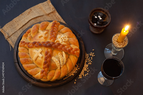 Serbian slava cake with wine and candle.  Slavski kolač. Decorative bread for traditional celebration.