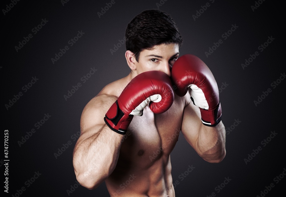 Sport background. Dramatic portrait of handsome boxer.