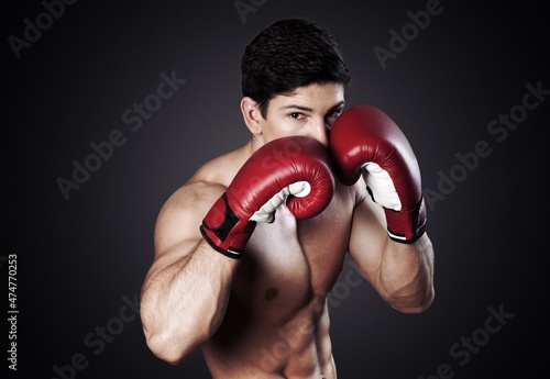 Sport background. Dramatic portrait of handsome boxer. © BillionPhotos.com
