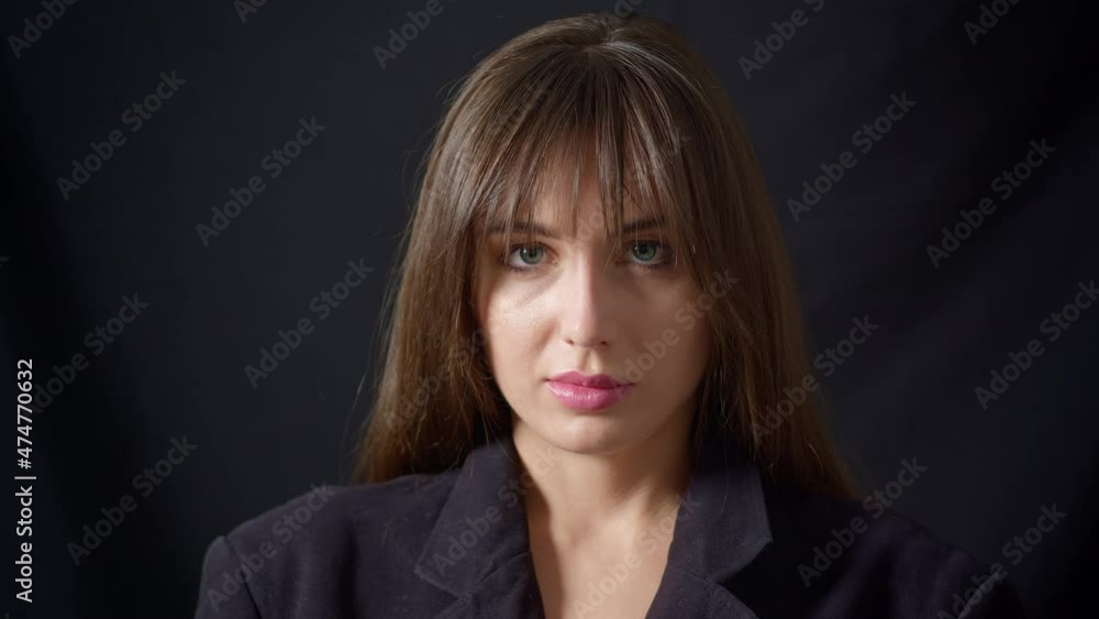The face of a sad and unhappy woman on a black background. The concept of violence, depression. The face of a sad and unhappy woman on a black background. The concept of violence, depression.