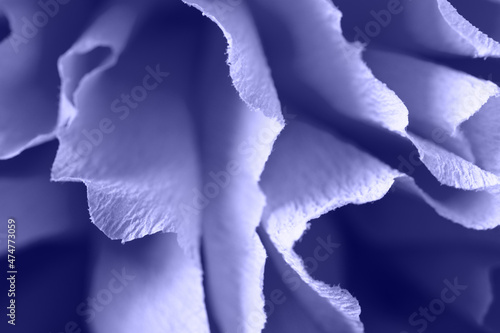 Fragment of a purple flower made of crepe paper. New trending Pantone color of 2022 - Very Peri