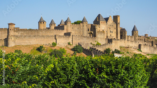 Famous hilltop town or ancient fortress La Cité de Carcassonne with medieval citadel or castle Château Comtal, surrounded by double walls, dotted by 52 towers and turrets, founded in Gallo-Roman times