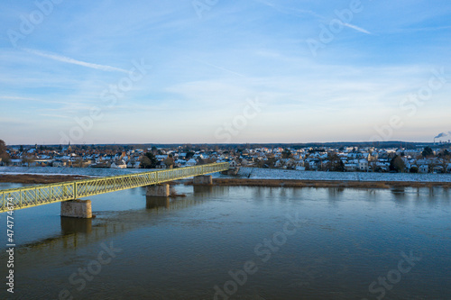 The pedestrian bridge of Sully sur Loire under the snow in Europe, in France, in the Center region, in the Loiret, towards Orleans, in Winter, during a sunny day. © Florent