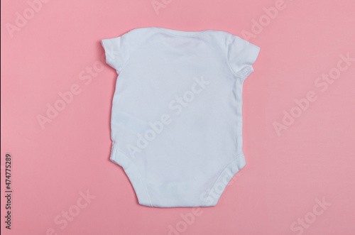 Baby body mockup, white on a colored background. Close up.