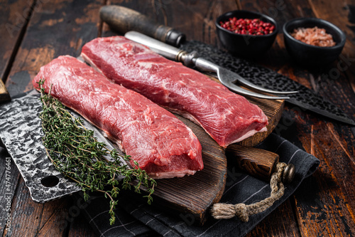 Raw lamb tenderloin fillet, Mutton fresh meat on butcher wooden board. Wooden background. Top view