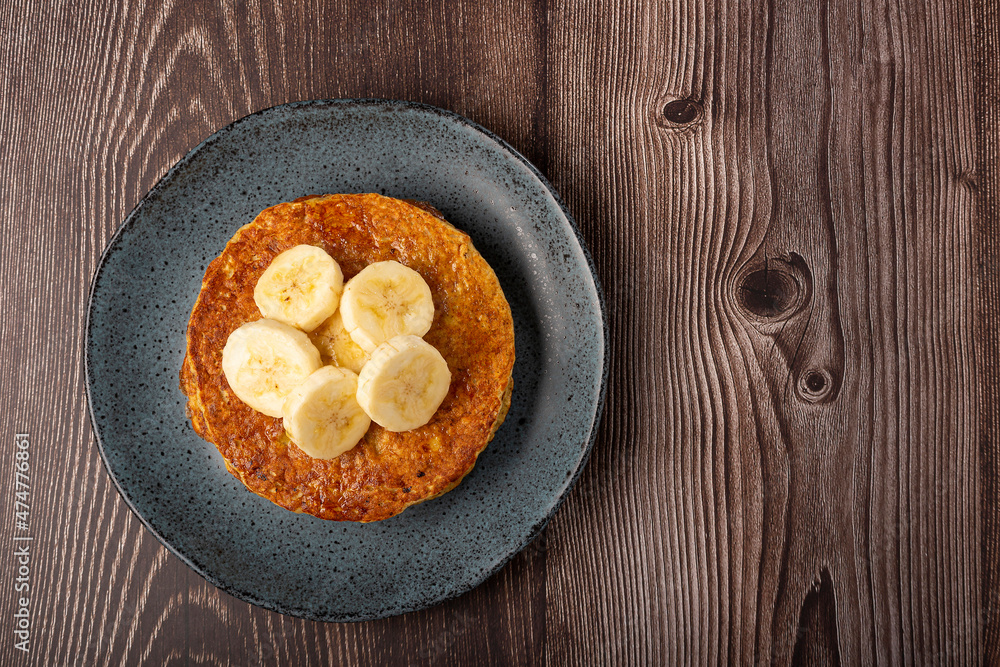 Banana oat pancakes topped with sliced bananas and honey. Banana oat pancakes topped with sliced bananas and honey.