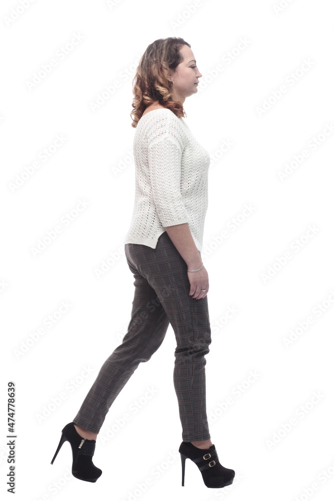 attractive young woman in a white jumper striding forward. attractive young woman in a white jumper striding forward.