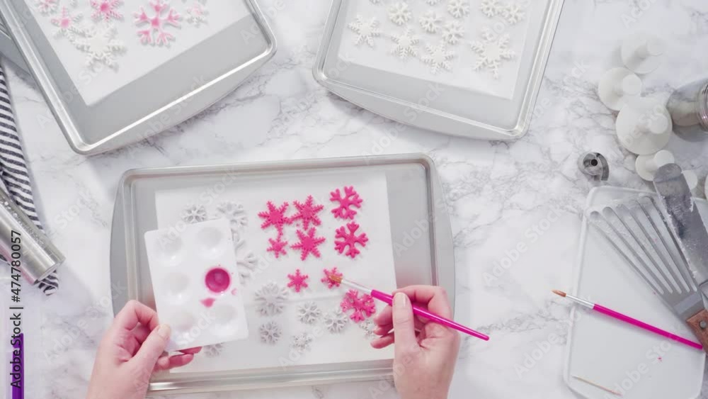 Flat lay. Step by step. Painting fondant snowflakes with food glitter. Flat lay. Step by step. Painting fondant snowflakes with food glitter.