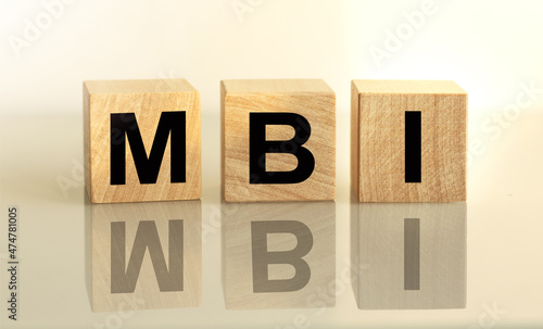 The inscription MBI on wooden cubes isolated on a light background, the concept of business and finance. photo