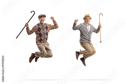 Fotografie, Obraz Full length portrait of cheerful elderly men with walking canes jumping
