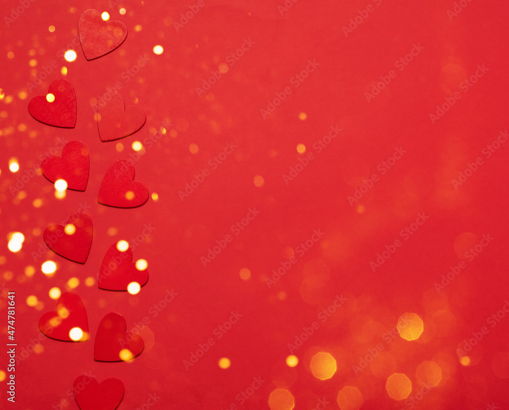 Red small hearts on a red background with sparkles and confetti. Festive background for Valentine's Day, Mother's Day