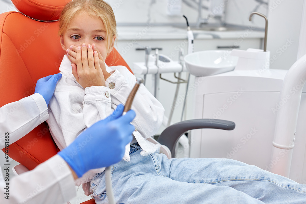 dentist is going to perform dental filling procedure to frightened