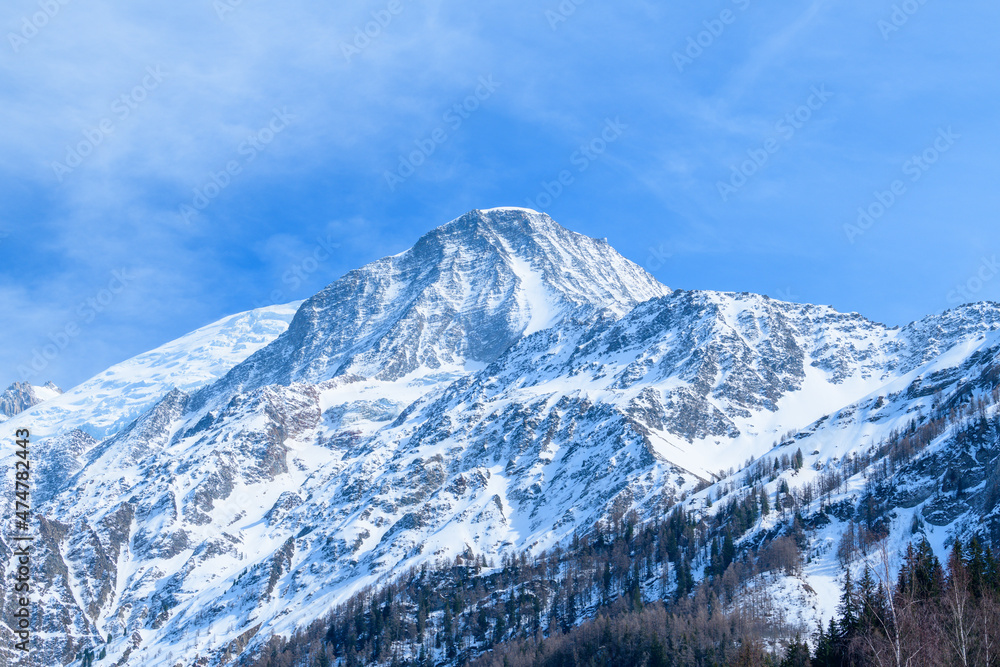The snowy Aiguille du Gouter in the Mont Blanc massif in Europe, France, the Alps, towards Chamonix, in spring, on a sunny day.