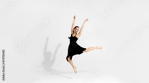 Pretty ballerina dancing ballet dance in studio