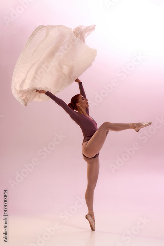 Fototapeta Naklejka Na Ścianę i Meble -  Fit beautiful ballerina dancing ballet with cloth