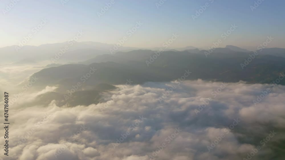 Aerial top view of forest trees and green mountain hills with sea fog, mist and clouds. Nature landscape background, Thailand. Aerial top view of forest trees and green mountain hills with sea fog, mist and clouds. Nature landscape background, Thailand.