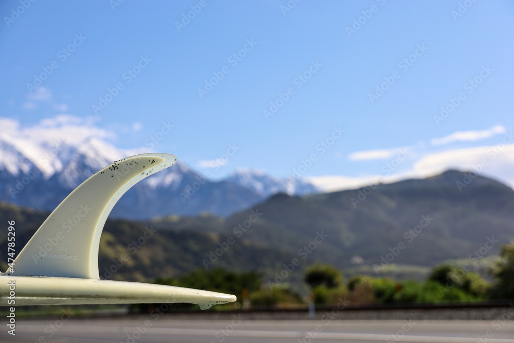 Surfboard with a mountain backdrop Surfboard with a mountain backdrop