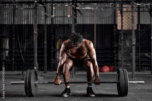Принти на полотні Cool strong african american male with confident face exercising holding equipment barbell up, lifts it with strength and power